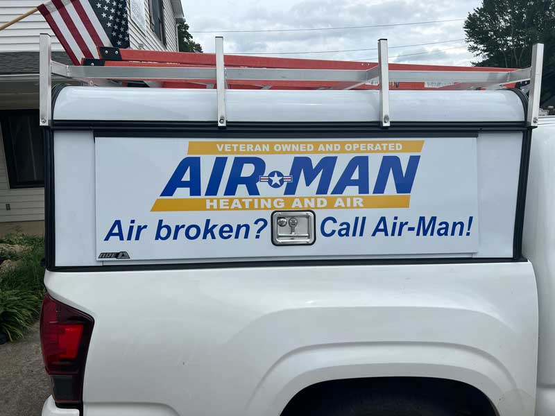 Air-Man Heating and Air service truck with 'Air broken? Call Air-Man!' lettering
