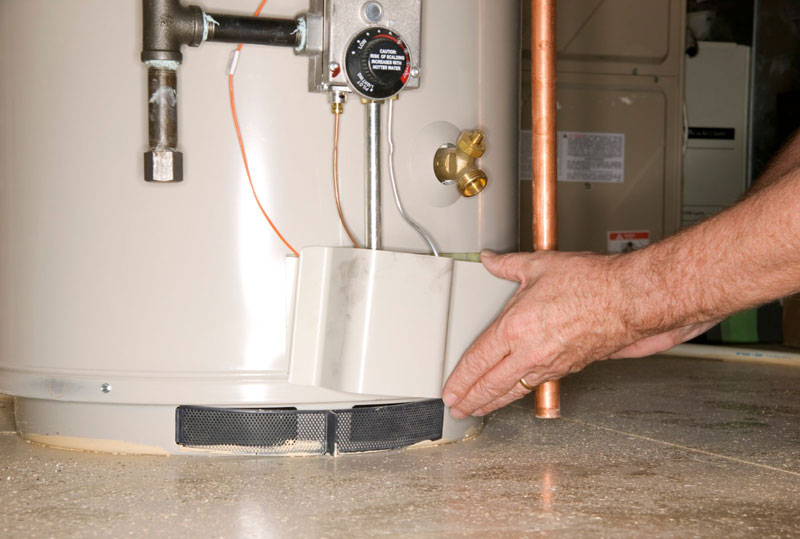 Technician checking the fittings on a residential water heater