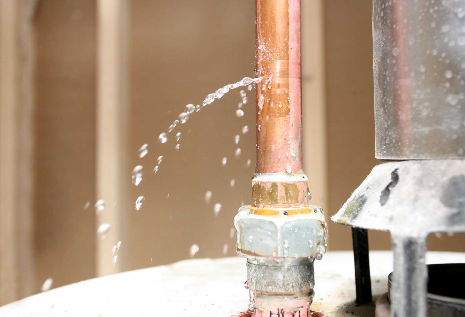 Water spraying from a leaking copper water pipe joint